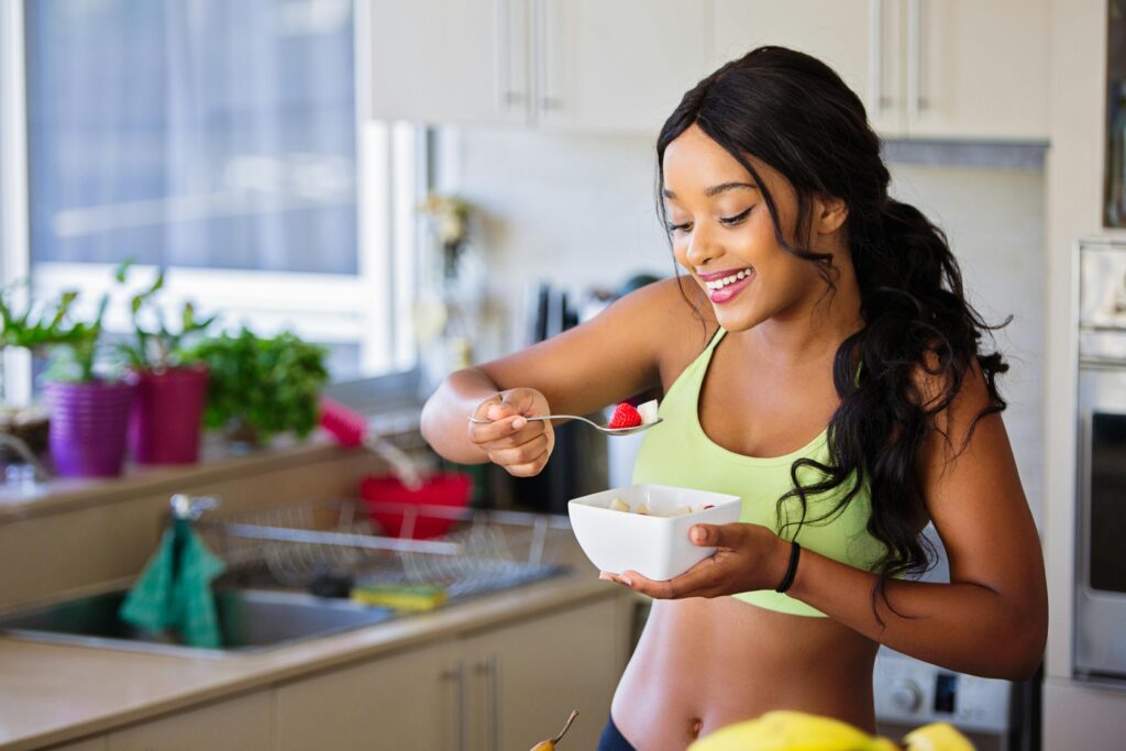 A woman eating in the kitchen