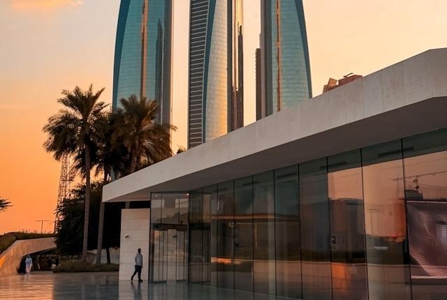 Person walking in front of buildings in Abu Dhabi 